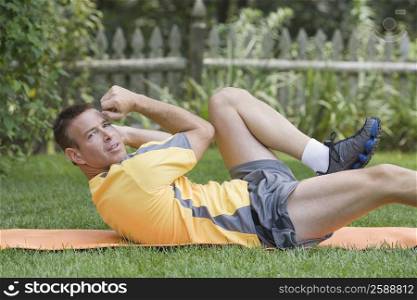Portrait of a mature man exercising in a garden