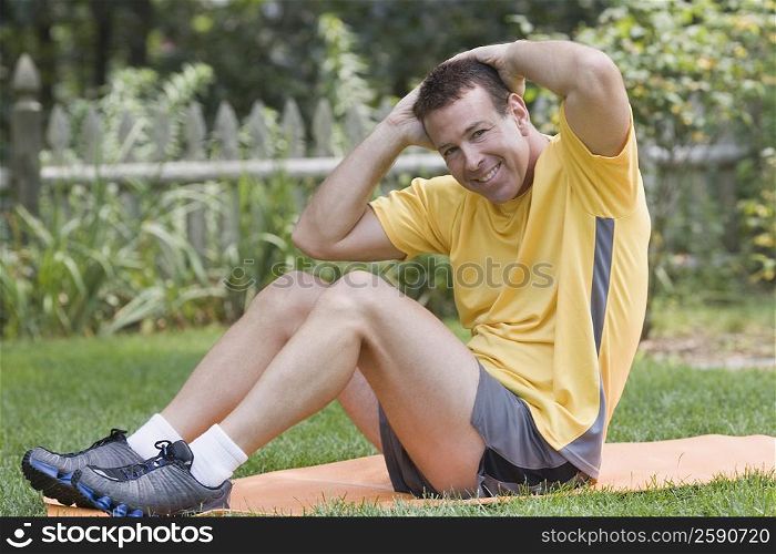 Portrait of a mature man exercising in a garden