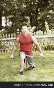 Portrait of a mature man exercising with dumbbells