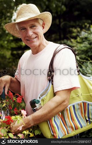 Portrait of a mature man gardening and smiling