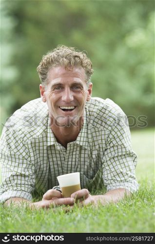 Portrait of a mature man holding a cold coffee cup