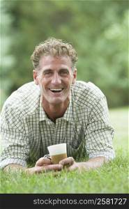 Portrait of a mature man holding a cold coffee cup