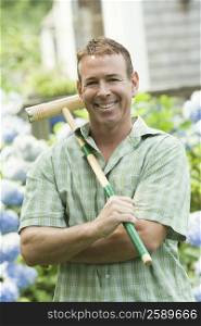 Portrait of a mature man holding a croquet mallet and smiling