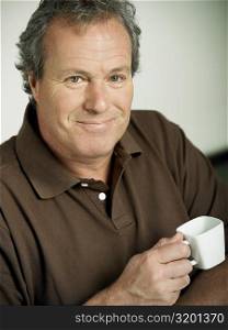 Portrait of a mature man holding a cup of tea