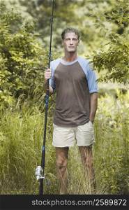 Portrait of a mature man holding a fishing rod