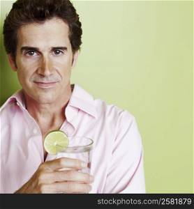 Portrait of a mature man holding a glass