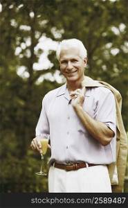Portrait of a mature man holding a glass of juice