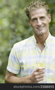 Portrait of a mature man holding a glass of wine and smiling