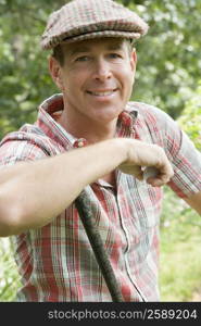 Portrait of a mature man holding a golf ball and smiling