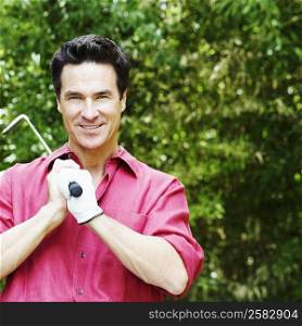 Portrait of a mature man holding a golf club
