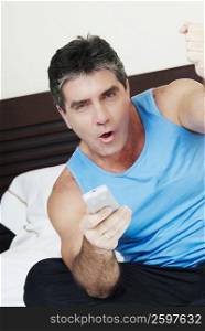 Portrait of a mature man holding a remote control