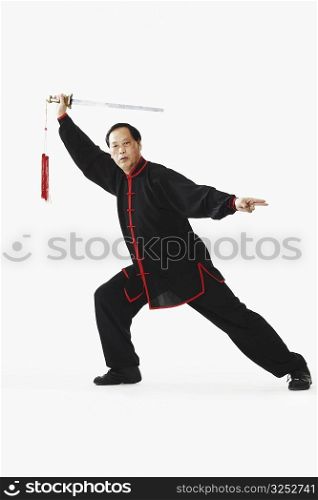 Portrait of a mature man holding a sword