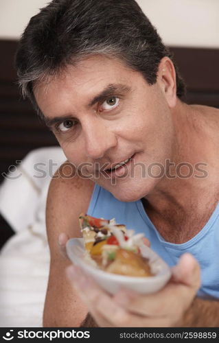 Portrait of a mature man holding a tart and smiling