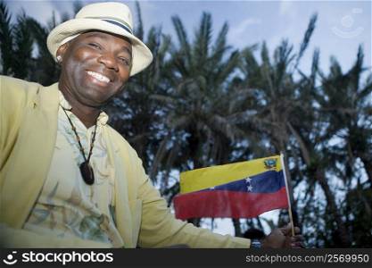Portrait of a mature man holding a Venezuelan flag