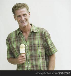 Portrait of a mature man holding an ice cream cone