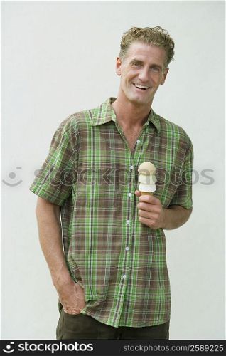 Portrait of a mature man holding an ice cream cone