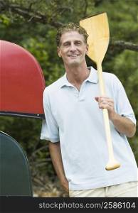 Portrait of a mature man holding an oar
