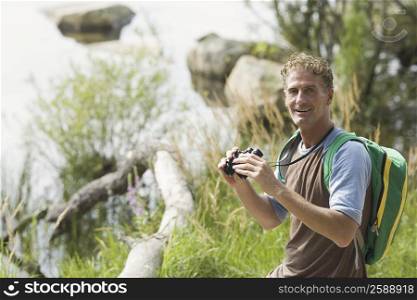 Portrait of a mature man holding binoculars