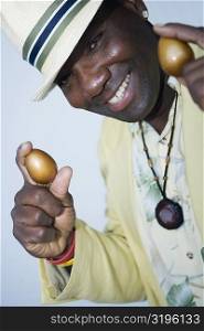 Portrait of a mature man holding two golden eggs