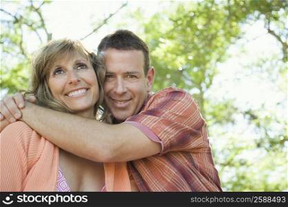 Portrait of a mature man hugging a mature woman and smiling