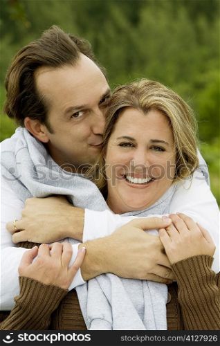 Portrait of a mature man kissing a mid adult woman