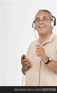Portrait of a mature man listening to an MP3 player and smiling