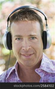 Portrait of a mature man listening to music with headphones