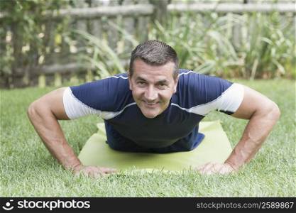Portrait of a mature man practicing push-ups