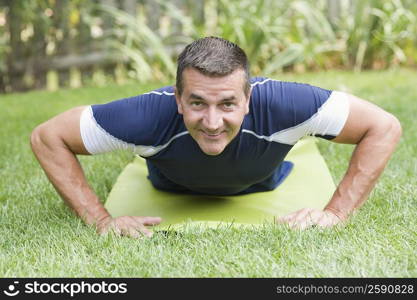 Portrait of a mature man practicing push-ups