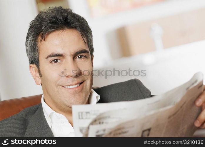 Portrait of a mature man reading a newspaper