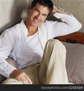 Portrait of a mature man reclining on the bed