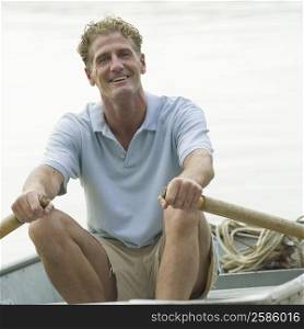 Portrait of a mature man rowing a boat