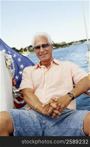 Portrait of a mature man sitting in a boat and smiling