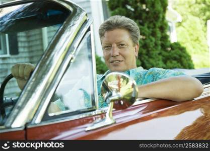 Portrait of a mature man sitting in a car