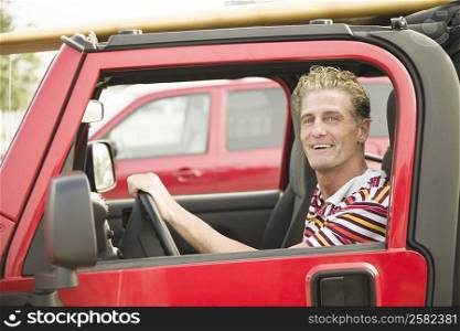 Portrait of a mature man sitting in a car and smiling