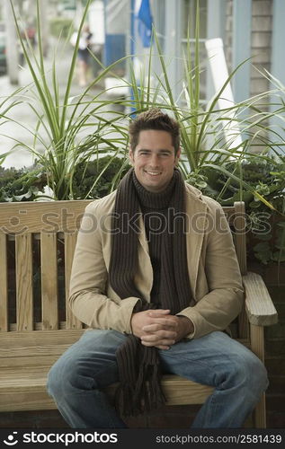 Portrait of a mature man sitting on a bench and smiling