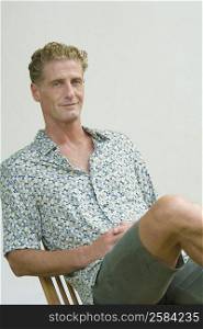 Portrait of a mature man sitting on a chair