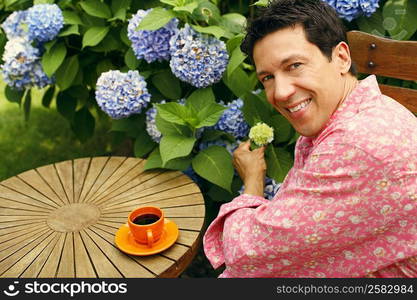 Portrait of a mature man sitting on a chair and smiling