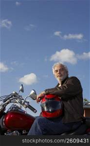 Portrait of a mature man sitting on a motorcycle