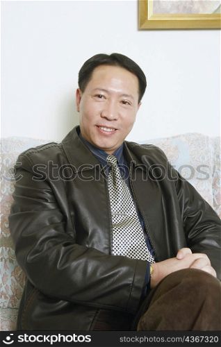 Portrait of a mature man sitting on couch