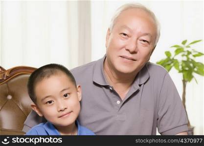 Portrait of a mature man sitting with his grandson