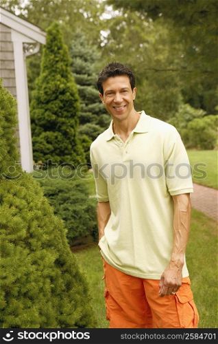 Portrait of a mature man smiling and standing in a park