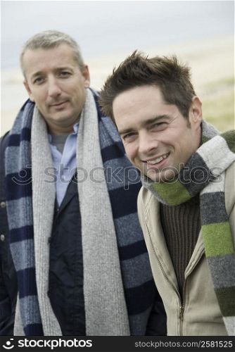 Portrait of a mature man smiling with his friend standing beside him