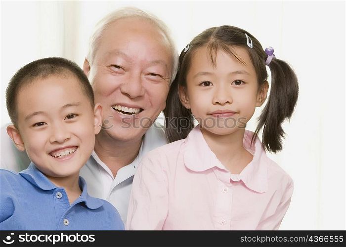 Portrait of a mature man smiling with his grandchildren