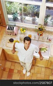 Portrait of a mature man standing in a kitchen
