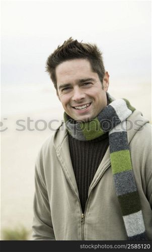 Portrait of a mature man standing on the beach and smiling