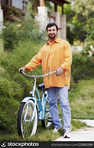 Portrait of a mature man standing with a bicycle