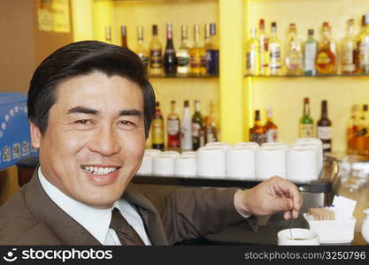 Portrait of a mature man stirring a cup of coffee