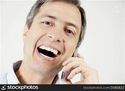 Portrait of a mature man talking on a mobile phone and laughing
