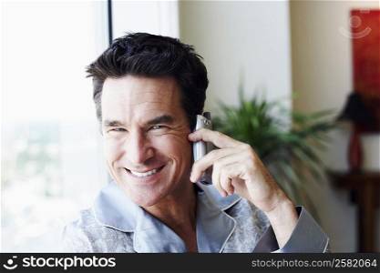 Portrait of a mature man talking on a mobile phone and smiling